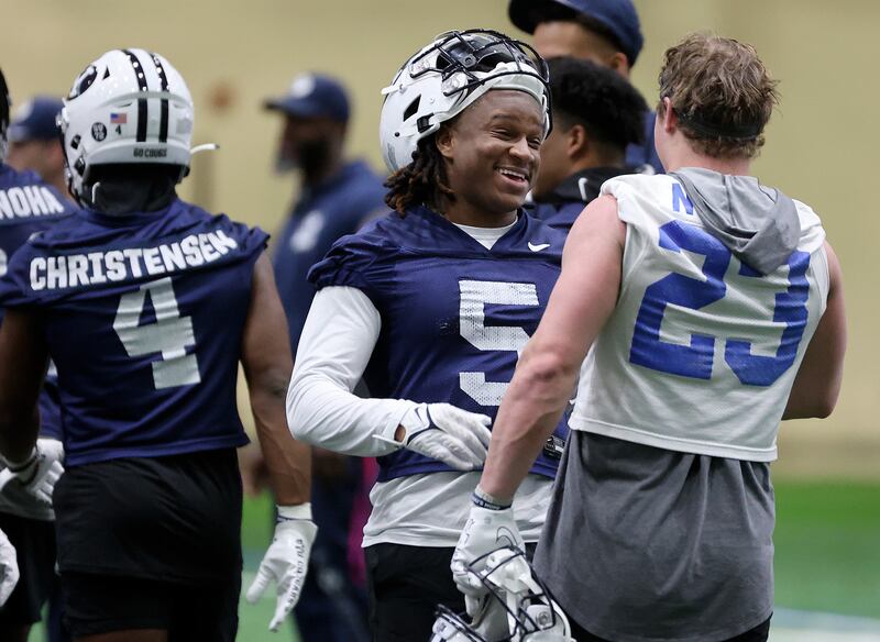 BYU cornerback Eddie Heckard and BYU wide receiver Hobbs Nyberg chat at the end of opening day of spring football camp.