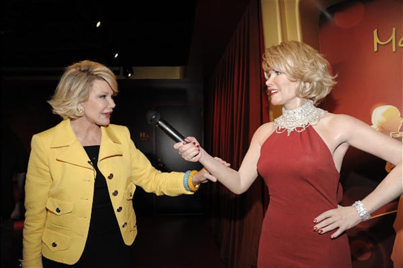 Comedian Joan Rivers touches a wax figure of herself while touring the new Madame Tussauds Hollywood in Los Angeles last week.