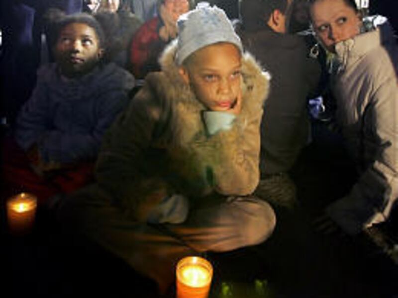 Angela Iton, 8, left, and Carmen Iton, 9, center, sit in protest outside of San Quentin State prison in San Quentin, Calif., Monday. Stanley Tookie Williams, the founder of the Crips gang, was executed Tuesday after midnight.