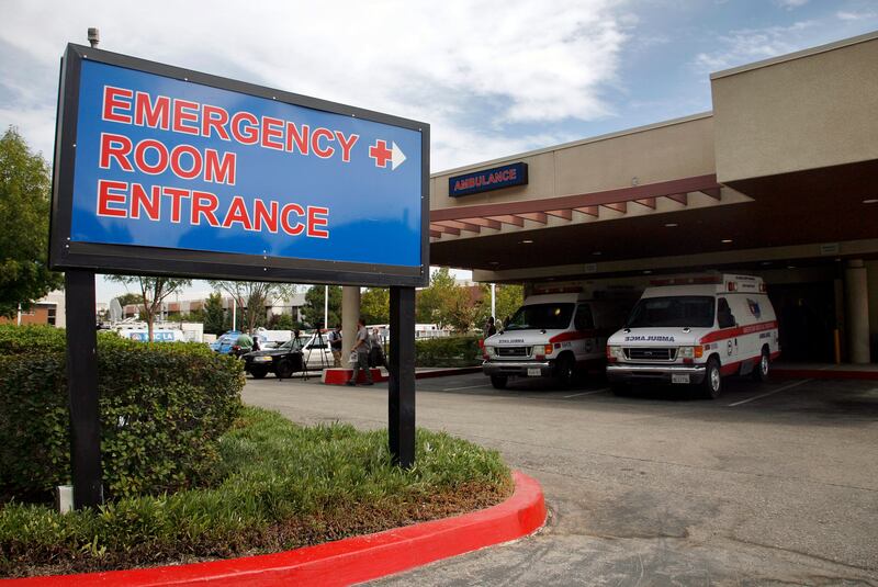 This Friday, Sept. 30, 2011, file photo shows the emergency room entrance at the Henry Mayo Newhall Memorial Hospital in Santa Clarita, Calif. In hard-hit Los Angeles County, Nerissa Black, a nurse at Henry Mayo Newhall Hospital, estimated she’s been averaging less than 10 minutes of care per patient every hour.