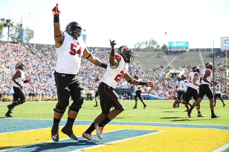 Utah Utes offensive lineman Isaac Asiata (54) and running back Joe Williams (28) celebrate