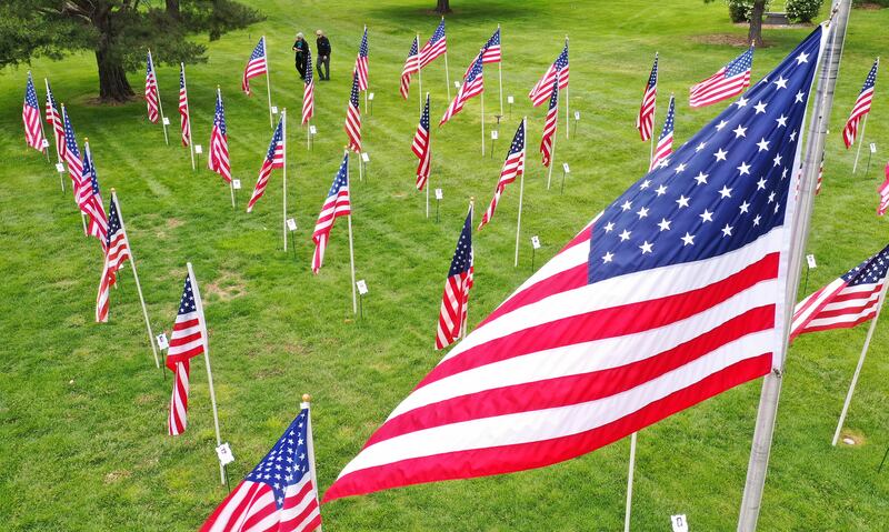 A couple walks through the Flags of Honor at Memorial Mountain View Cemetery in Cottonwood Heights on May 24, 2020.