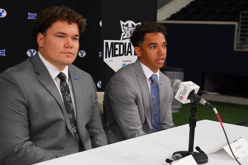 BYU running back LJ Martin, right, speaks as teammate defensive lineman Keanu Tanuvasa looks on during Big 12 football media days in Frisco, Texas, Tuesday, July 8, 2025.