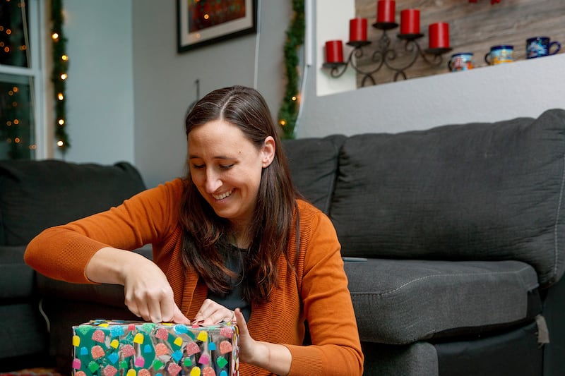 Heather Aliano wraps Christmas presents for her children on Wednesday, Nov. 28, 2018, at her home in Bellevue, Nebraska. Aliano, a mother of four, limits the number of gifts her children receive at Christmas.
