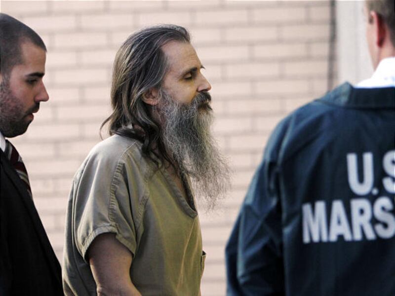 Brian David Mitchell, who is accused of kidnapping Elizabeth Smart, is escorted into federal court Thursday. His trial has been put on hold while an appeals court considers whether it should be moved from Utah.