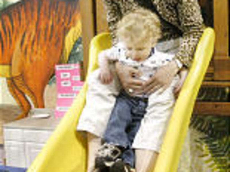 Linnea Charnholm and her son, Tor, 2, play at Backyard Adventures in Sandy during a MOMS Club gathering.