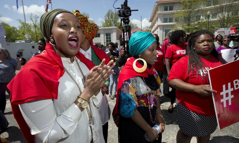 Fahima Abdi of Somalia, from left, and Sadiyah Bashir, join a rally in front of the Nigerian embassy in northwest Washington, Tuesday, May 6, 2014, protesting the kidnapping of nearly 300 teenage schoolgirls, abducted from a school in the remote northeast
