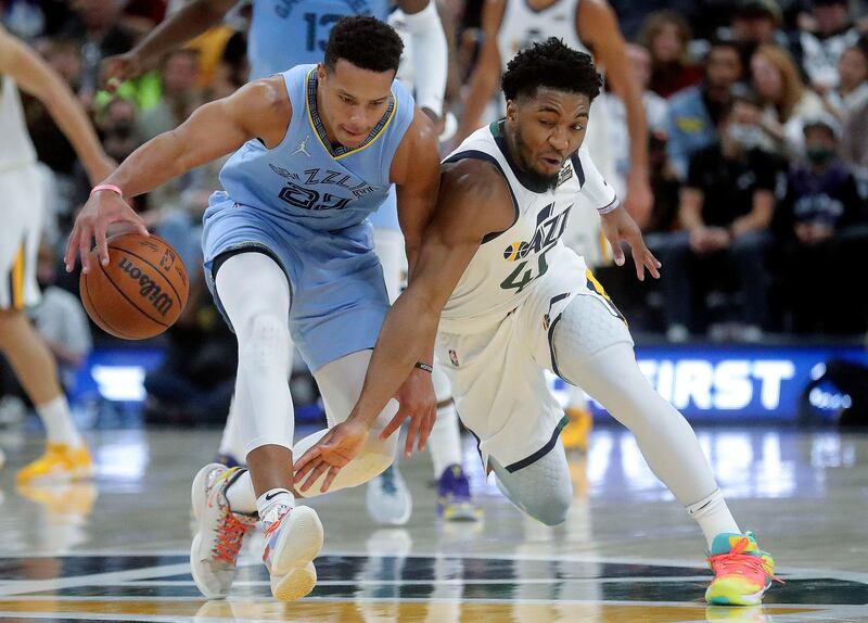 Utah’s Donovan Mitchell tries to get the ball away from Memphis’ Desmond Bane during game at the Vivint Arena in Salt Lake.