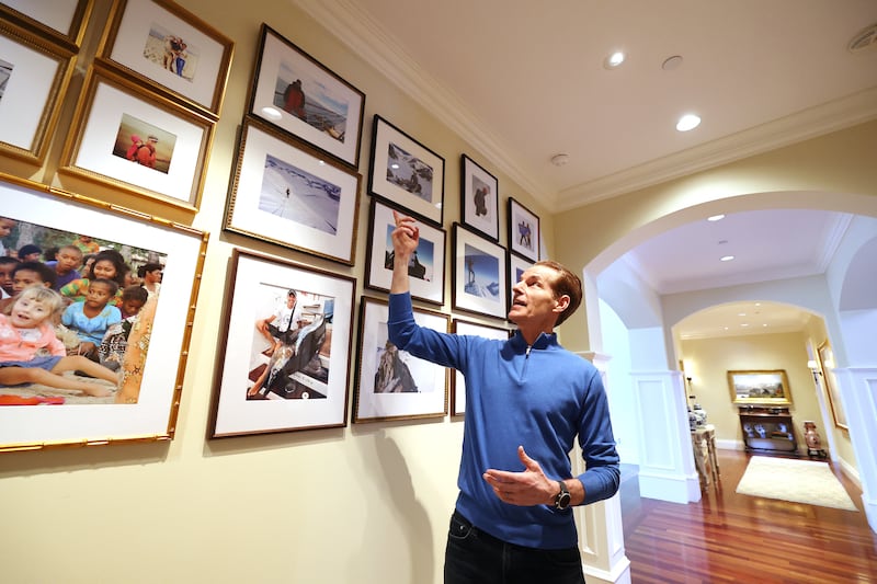 Martin Frey points out photos as he describes his experiences of climbing the Seven Summits and sailing the Seven Seas.