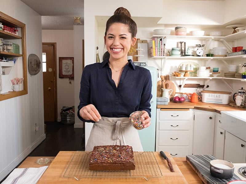 Molly Yeh prepares a batch of her Olive Oil Blondies with chocolate frosting and sprinkles.