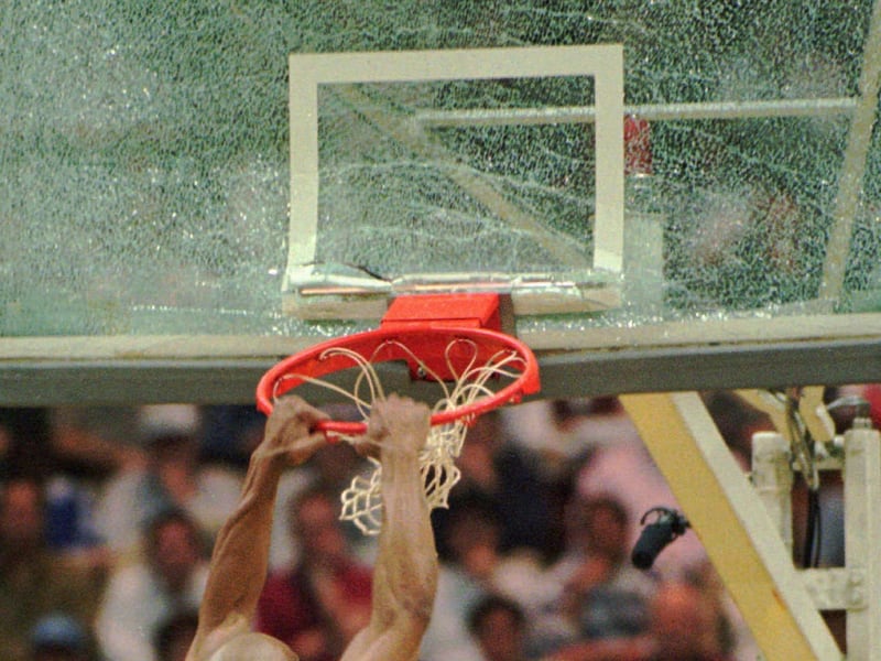 Texas Tech forward Darvin Ham pulls down the backboard and breaks the glass during game Sunday March 17,1996 at the Richmond Coliseum in Richmond, Va.