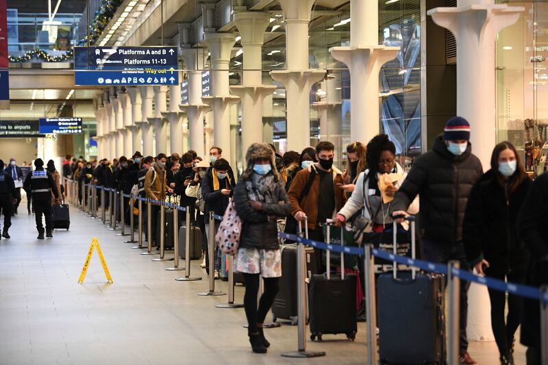 In this Sunday Dec. 20, 2020 file photo people at St Pancras station in London, wait to board the last train to Paris today. Instead of Christmas joy, a sense of dread and isolation is looming.