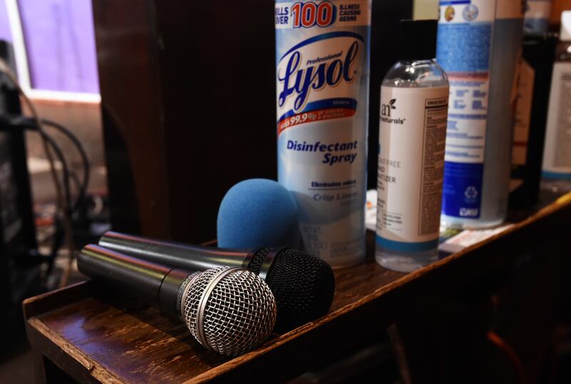 Microphones sit near Lysol disinfectant spray before a “Laughter is Healing” stand-up comedy livestream event at the Laugh Factory comedy club, Monday, April 20, 2020, in Los Angeles.