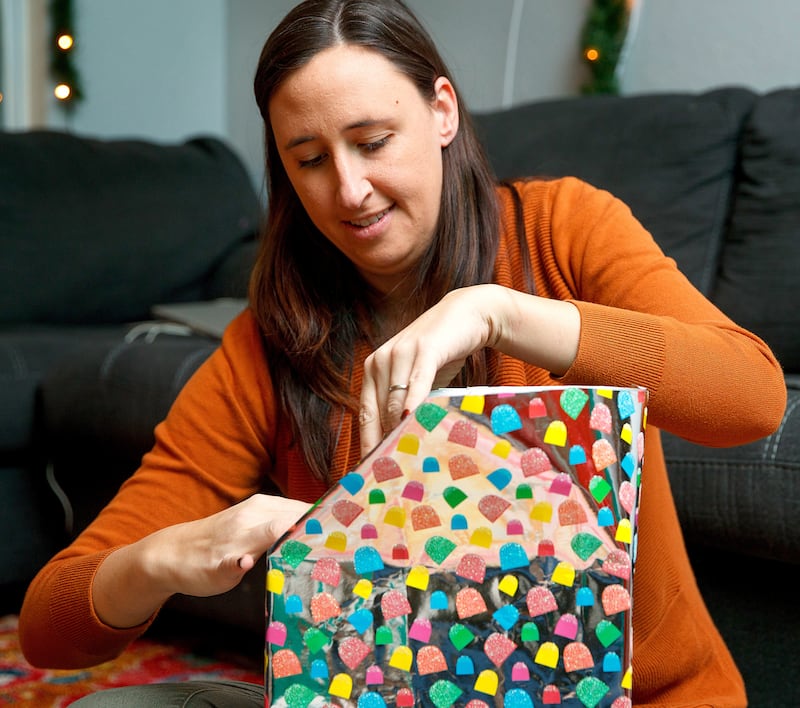 Heather Aliano wraps Christmas presents for her children on Wednesday, Nov. 28, 2018, in Bellevue, Nebraska. Aliano, a mother of four, limits the number of gifts her children receive at Christmas.