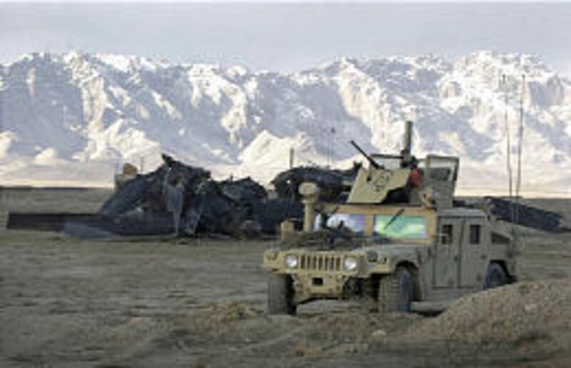 A U.S. Humvee guards the scene of a U.S. helicopter crash in the Zabul province in southeastern Afghanistan on Sunday.