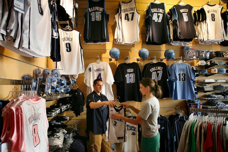 FILE - Fanzz store manager Kenny Evans helps Haley Voorhees selects some Utah Jazz items to purchase at the Gateway Center, May 14, 2007 in Salt Lake City, Utah.