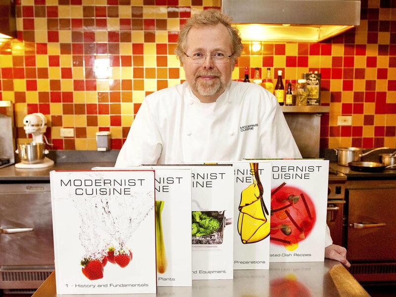 FILE - In this March 23, 2011 file photo, Nathan Myhrvold, author of "Modernist Cuisine: The Art and Science of Cooking," as he poses with five books from the work at the Institute for Culinary Education in New York. On Friday, May 4, 2012, Myhrvold won a