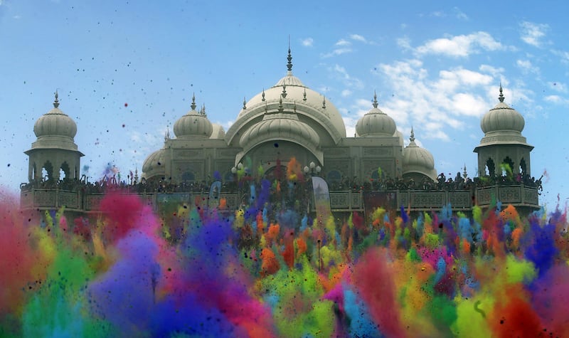 Revelers throw colored corn starch into the air as they celebrate the 2015 Holi (Festival of Colors) at the Krishna Temple in Spanish Fork, Utah on Saturday, March 28, 2015. (AP Photo/Rick Bowmer)