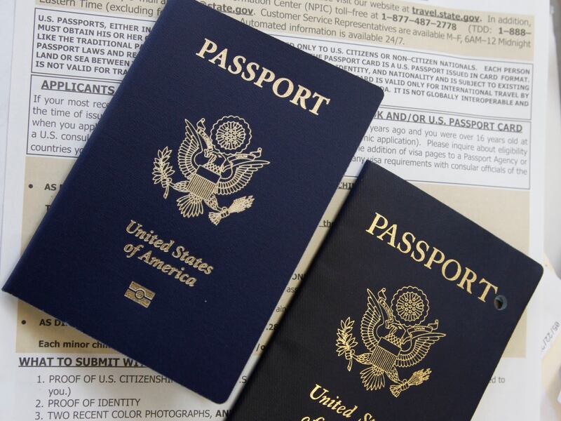 A new United States passport beside an expired pierced passport.