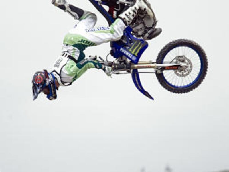 Nate Adams of Glendale, Ariz., flies upside down in the final round of the freestyle motocross event in the Dew Tour outside EnergySolutions Arena. Adams was the freestyle motocross champion after a high score of 93.33.