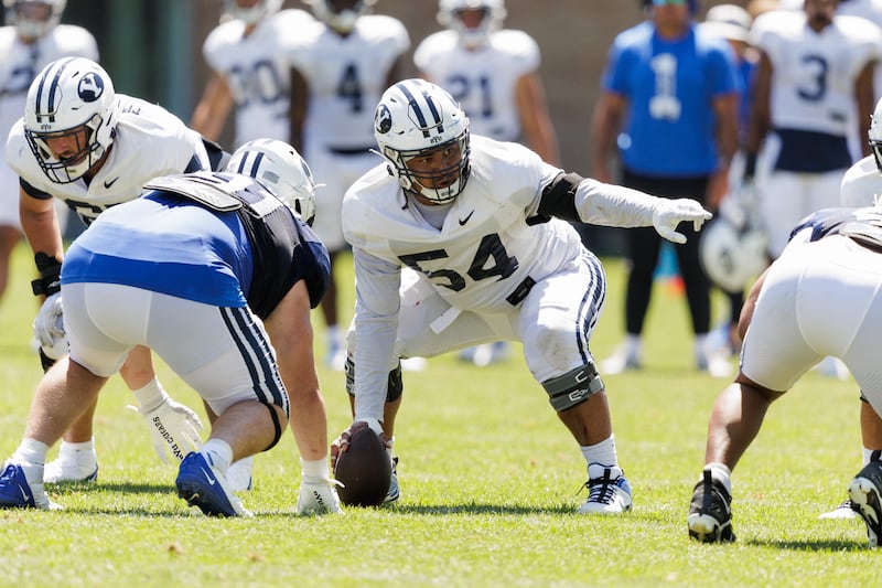 University of Utah transfer Paul Maile prepares to snap the ball during BYU practice earlier this month in Provo.