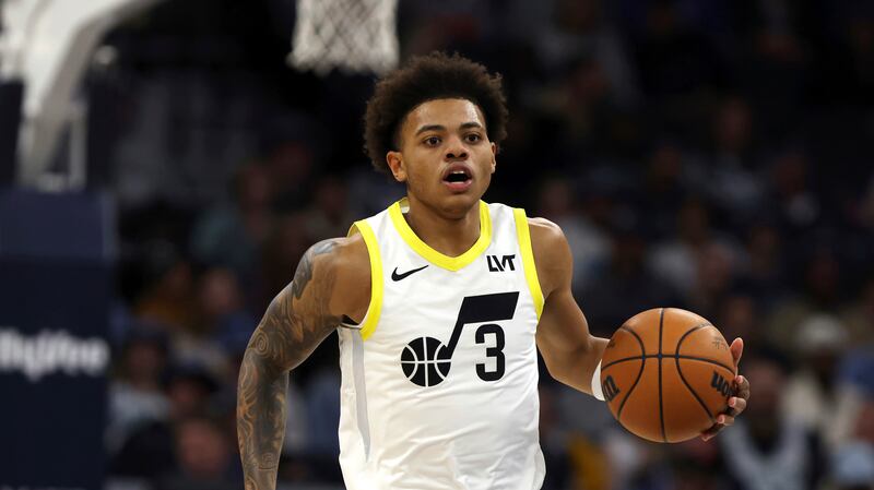 Utah Jazz guard Keyonte George (wearing white) handles the ball against the Minnesota Timberwolves during the first half of an NBA basketball game Saturday, Nov. 4, 2023, in Minneapolis.