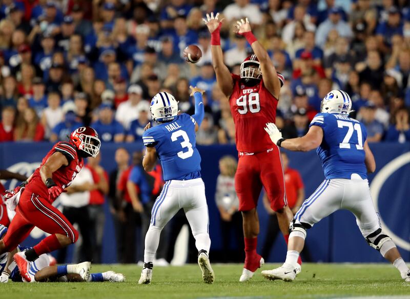 Utah Utes defensive tackle Viane Moala tries to knock down a pass by Brigham Young Cougars quarterback Jaren Hall.