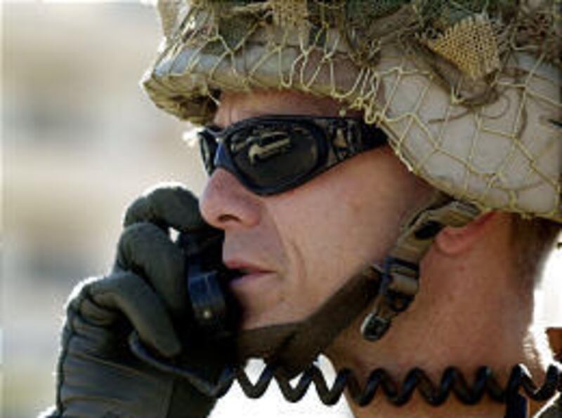 Lt. Col. Steve Russell of the 4th Infantry Division supervises troops in Saddam Hussein's hometown of Tikrit. The number of U.S. troops in Iraq will fall to 105,000 by May.