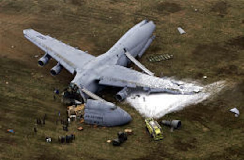 Emergency crews respond to the scene of a military cargo plane crash Monday at Dover Air Force Base in Delaware.