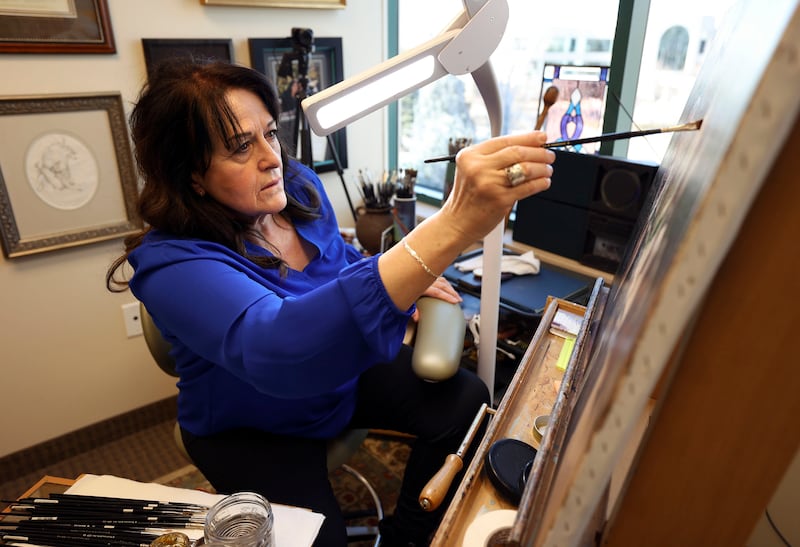 Liz Lemon Swindle works on a painting inspired by “The Chosen” in her studio in Provo, Utah.
