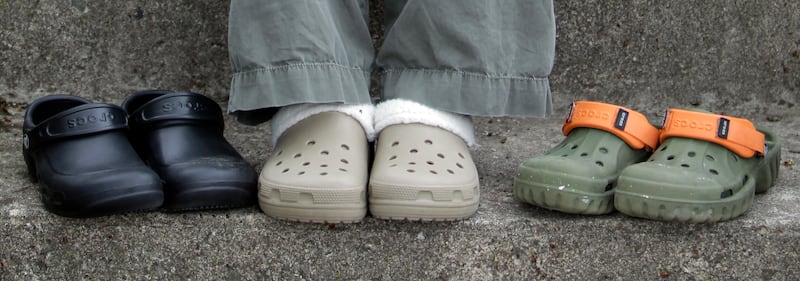 In this photo taken April 8, 2010, Emily Auth displays some of her collection of Crocs outside her home in Kokomo, Ind. Auth calls herself a Crocs hypocrite because she mocked the shoes when she first saw them. But the 25-year-old loves them so much she ended up wearing red high-heel Crocs at her wedding last summer.