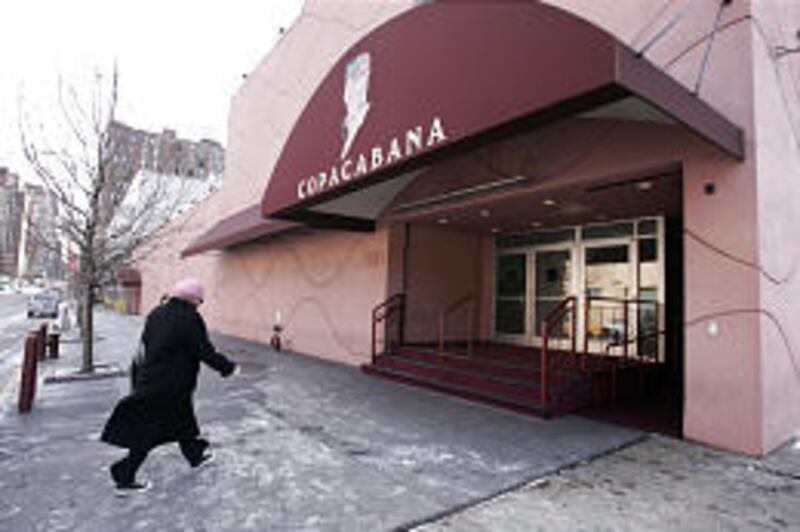 A woman walks toward the Copacabana in New York in January. The club closed because of construction of a new subway line.