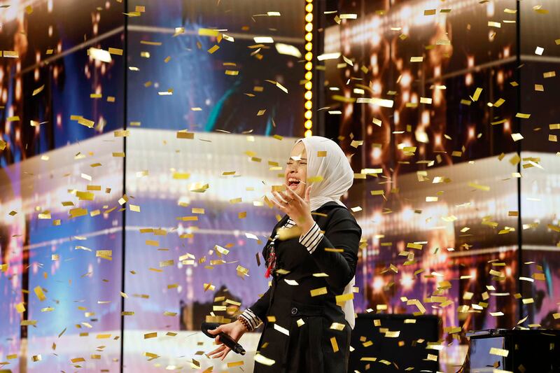 Putri Ariani receives a golden buzzer from Simon Cowell on “AGT.”