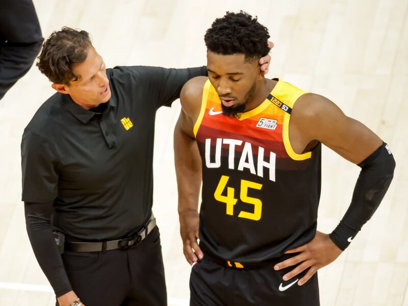 Utah Jazz head coach Quin Snyder puts his hand on the back of the head of Utah Jazz guard Donovan Mitchell.