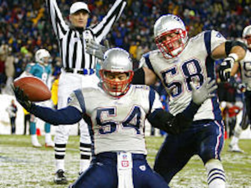 Patriots Tedy Bruschi, front, and Matt Chatham celebrate Bruschi's 5-yard interception return for a touchdown. It was the game's only TD.