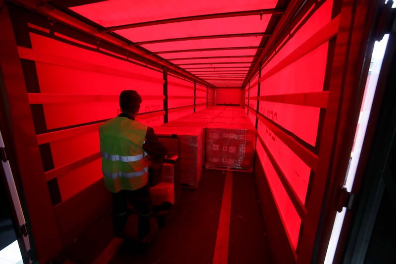 A worker unloads a truck transporting medical supplies in the outskirts of Minsk, Belarus.