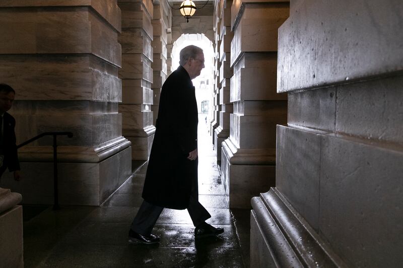 Senate Majority Leader Mitch McConnell, R-Ky., arrives at the Capitol as work continues to meet a Friday night deadline to avoid a partial government shutdown in Washington, Friday, Dec. 21, 2018.