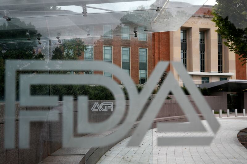 This Aug. 2, 2018 file photo shows the U.S. Food and Drug Administration building behind FDA logos at a bus stop on the agency's campus in Silver Spring, Md.