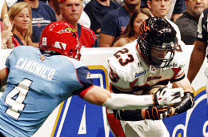 Utah Blaze wide receiver Tom Pace, who scored three touchdowns, collides with Los Angeles defensive back Eddie Canonico.