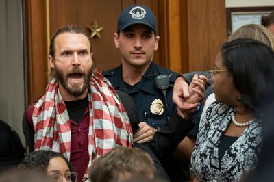 A protester shouts at former special counsel Robert Mueller as he arrived to testify to the House Judiciary Committee about his investigation into President Donald Trump and Russian interference in the 2016 election, on Capitol Hill in Washington, Wednesd
