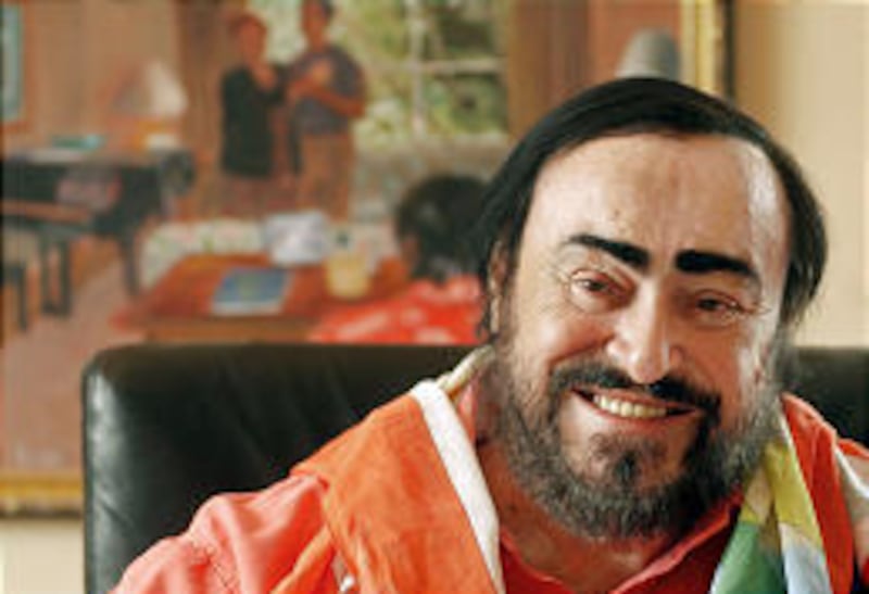 Tenor Luciano Pavarotti smiles in his New York apartment Friday. He said Saturday's performance, his 379th at the Met, would be his last night of staged opera anywhere.