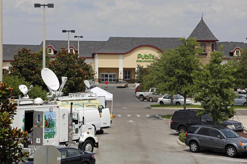 Satellite trucks line the parking lot where the highest Powerball jackpot worth an estimated $590.5 million was sold recently at this Publix supermarket located in Zephyrhills, Fla. on Sunday May 19, 2013.
