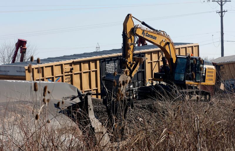 Work crews clean up the derailment of a Norfolk Southern cargo train in Clark County, Ohio, Sunday, March 5, 2023. The National Transportation Safety Board announced on Tuesday that it will be looking into the safety practices of train company Norfolk Southern.