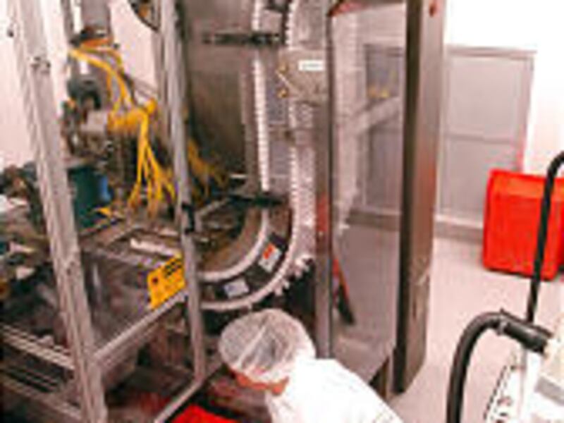 Cephalon pharmaceutical technician Rebecca Montano monitors carton feeding of drug Actiq in Salt Lake.
