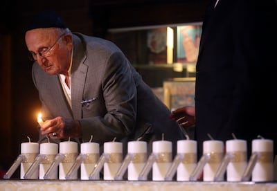 Holocaust survivor Abe Katz starts to light 11 candles, for the 11 victims of the shooting at the Tree of Life Synagogue in Pittsburgh, during a vigil and prayer service at Chabad Lubavitch of Utah in Salt Lake City on Monday, Oct. 29, 2018.