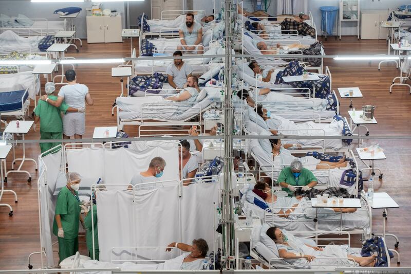 COVID-19 patients rest in a field hospital built inside a sports coliseum in Santo Andre, Brazil.
