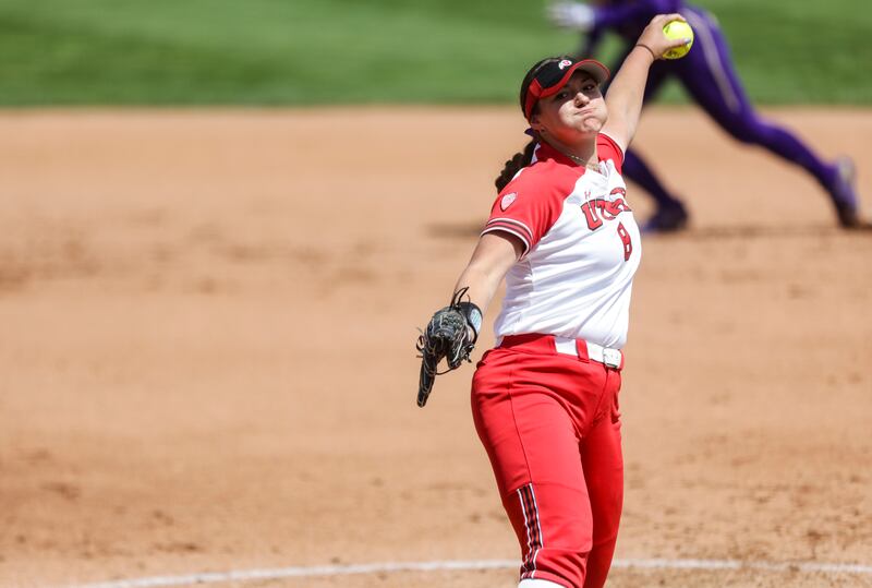 Utah pitcher Mariah Lopez (wearing white) delivers a pitch