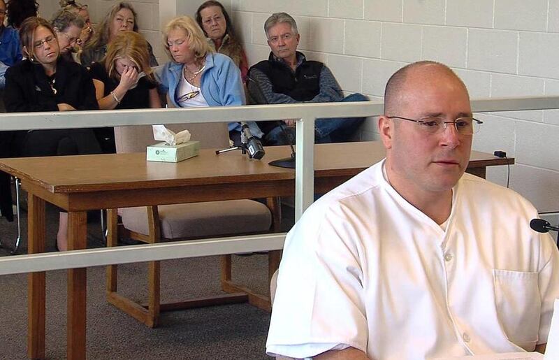 Rape victim Rebecca Mills, second from left, cries March 27, 2012, during a parole hearing for convicted serial rapist Jason Brett Higgins, right, at the Utah State Prison. The Utah Board of Pardons and Parole determined Higgins should spend his entire li