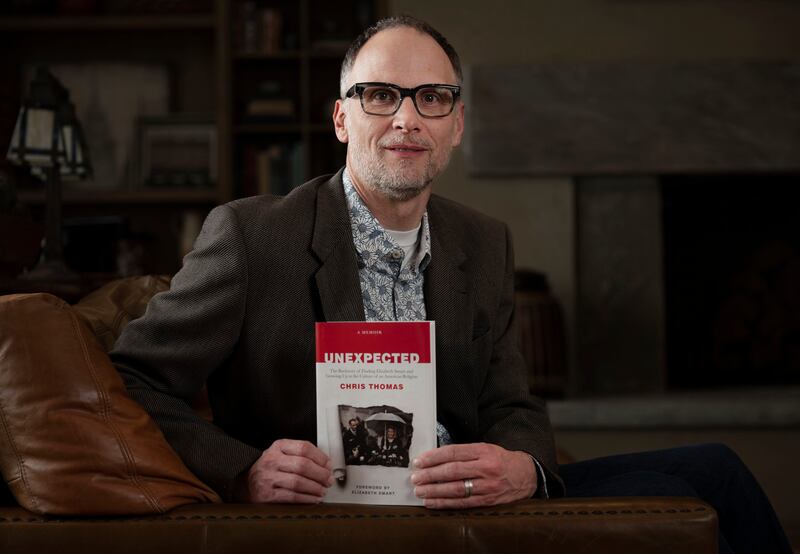 Chris Thomas is photographed with his book “Unexpected” in Holladay.