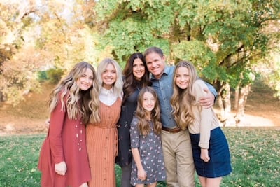 Ben Cahoon is photographed with his wife and daughters.